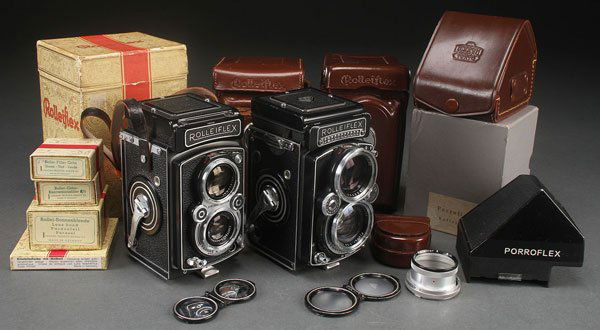 TWO ROLLEIFLEX ROLL FILM CAMERAS, MID 20TH C: TWO ROLLEIFLEX ROLL FILM CAMERAS, MID 20TH CENTURY. Comprising a model EII with Carl Zeiss 80mm f2.8 Planar lens, serial# 2357450, and an earlier Rolleiflex with Schneider 75mm f3.5 Zenar lens. Each w