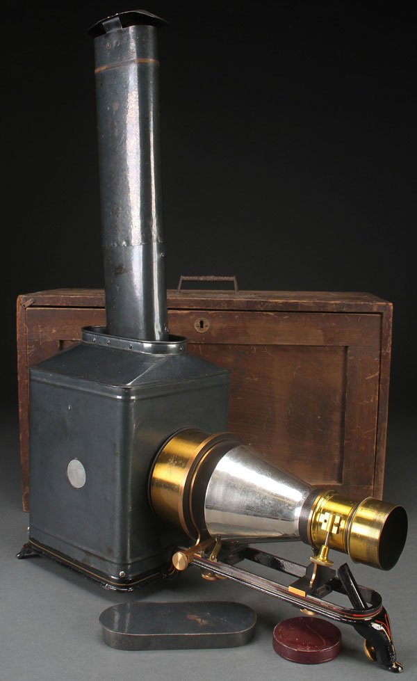 MCINTOSH MAGIC LANTERN PROJECTOR, CIRCA 1900. In: MCINTOSH MAGIC LANTERN PROJECTOR, CIRCA 1900. In original wooden case, McIntosh Battery and Optical Company, 1889 – 1900, Chicago, Illinois, has a tall 20-inch chimney. Length in case 22 inches (56