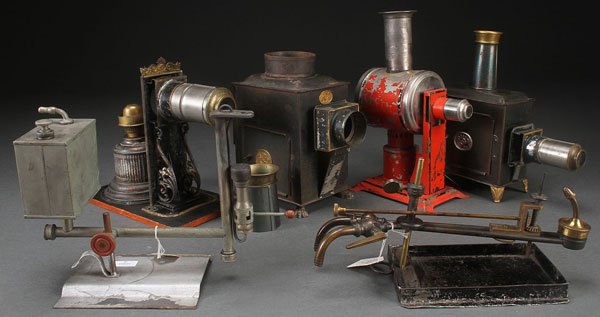 A MAGIC LANTERN AND LATERN PARTS AND ACCESSORY: A MAGIC LANTERN AND LATERN PARTS AND ACCESSORY GROUP, MOSTLY LATE 19TH CENTURY. Comprising a red polychrome Jean Schoenner and Ernst Plank standard, together with various burners including a gas illum