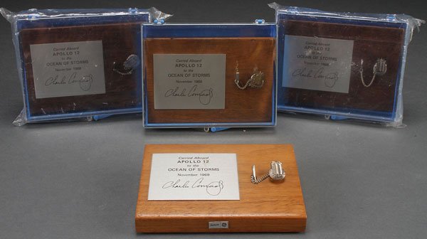 A GROUP OF FOUR APOLLO 12 LUNAR MODULE FLOWN TIE: A GROUP OF FOUR APOLLO 12 LUNAR MODULE FLOWN TIE TACS, 1969. Each pin depicting SNAP 27 RTG – A Systems Nuclear Auxiliary Power Radioisotope Thermoelectric Generator, with the moon in the background