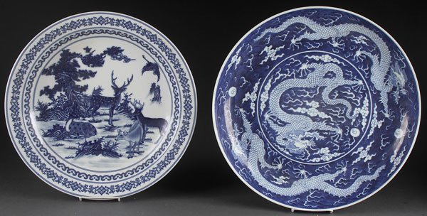 A PAIR OF LARGE CHINESE BLUE AND WHITE PORCELAIN CHARGE: A PAIR OF LARGE CHINESE BLUE AND WHITE PORCELAIN CHARGERS. Comprising a scenic deer and pinetree with interlocking Ruyi form border and with Kangxi mark in blue underglaze and Ming style dragons with 