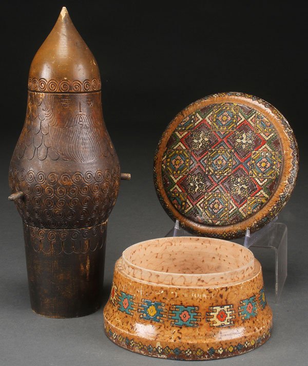 A PAIR OF RUSSIAN KUSTAR PYROGRAVURE ITEMS, FIRST: A PAIR OF RUSSIAN KUSTAR PYROGRAVURE ITEMS, FIRST HALF OF THE 20TH CENTURY. Comprising a two-piece Bogatyr and a trompe-l’oeil circular box with fitted lid with faux birch grain and faux embroidere