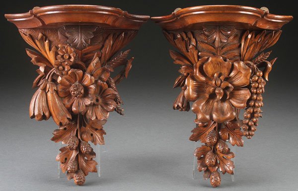 A PAIR OF VICTORIAN CARVED WOOD WALL BRACKETS: A PAIR OF VICTORIAN CARVED WOOD WALL BRACKETS. Each with floral and leaf decoration in deep extending relief. Height 12.25 inches (31 cm).