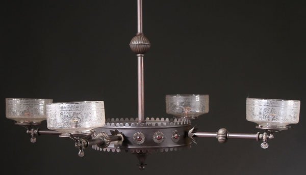 AN EASTLAKE VICTORIAN JEWELED GAS LIGHT FIXTURE: AN EASTLAKE VICTORIAN JEWELED GAS LIGHT FIXTURE, CIRCA 1875. Mounted with ruby colored jewels in embossed rosette form bezels, dark bronzed finish overall, with four elongated arms surmounted by folia