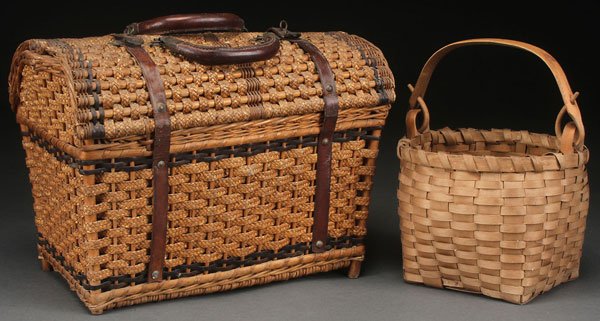 A PAIR OF 19TH CENTURY WOVEN BASKETS: A PAIR OF 19TH CENTURY WOVEN BASKETS. Comprising a wicker and straw woven lidded basket with leather straps and handles and a small carved handled splint basket. The largest length 13.5 inches (34 cm)