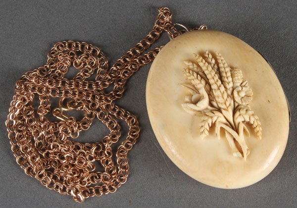 A RUSSIAN CARVED IVORY LOCKET, 18TH CENTURY.: A RUSSIAN CARVED IVORY LOCKET, 18TH CENTURY. Opening to reveal a hand-painted miniature bust profile portrait of Catherine the Great, dated 1781. And with later Soviet period gold chain. The locket 1.