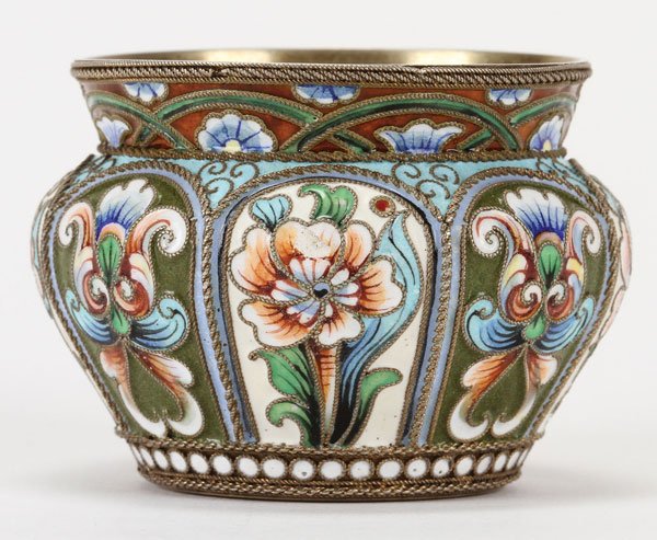 A RUSSIAN SILVER-GILT AND SHADED ENAMEL BRATINA: A RUSSIAN SILVER-GILT AND SHADED ENAMEL BRATINA, MOSCOW, CIRCA 1908-1917. With lobed arched panels, each depicting a floral motif above a beaded cloisonné banded base and beneath a slightly flared ri
