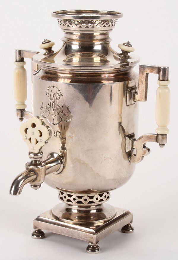 A VERY FINE RUSSIAN SILVER-GILT MINIATURE SAMOVAR: A VERY FINE RUSSIAN SILVER-GILT MINIATURE SAMOVAR, GRACHEV, ST. PETERSBURG, 1897. Of traditional form resting on four bun feet with ornate side handles, lid, and spigot each ivory mounted, and on the