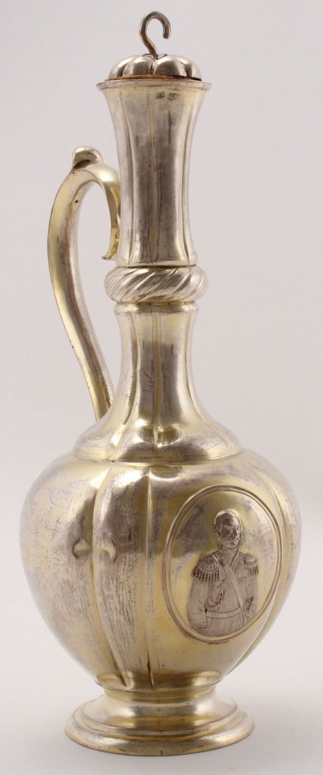 A RUSSIAN SILVER-GILT TSAR ALEXANDER II WINE: A RUSSIAN SILVER-GILT TSAR ALEXANDER II WINE CARAFE, ANDRÉ BEKMAN, MOSCOW, DATED 1864. Resting on a slightly flared footed base, the bulbous body with ribbed sides and displaying a large oval medall