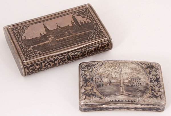 A PAIR OF SILVER AND NIELLO RUSSIAN SNUFF BOXES: A PAIR OF SILVER AND NIELLO RUSSIAN SNUFF BOXES, MOSCOW 1845-1890. The first comprising a large box with rounded sides and overall nielloed with scrolling vines on a stippled ground. The underside wit