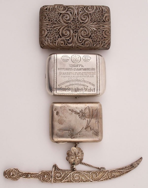 A FOUR-PIECE RUSSIAN SILVER GROUP: A FOUR-PIECE RUSSIAN SILVER GROUP, CIRCA 1880-1917. Comprising a silver filigree cigarette case. Hallmarked Moscow, circa 1899-1908 and with Cyrillic maker's mark "AG." Length 3.5 inches (8.7 cm). Tog