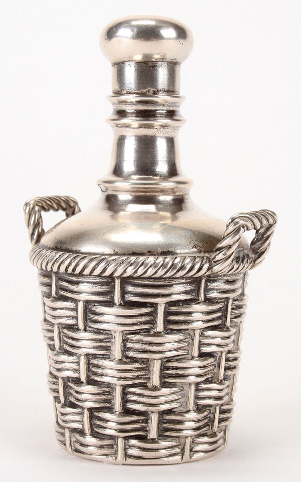 A RUSSIAN SILVER TROMPE L'OEIL SCENT BOTTLE: A RUSSIAN SILVER TROMPE L'OEIL SCENT BOTTLE, MOSCOW, 1892. The silver body crafted to simulate woven basketry and the bottle with twist off cap. Hallmarked Moscow, dated 1892, with indistinguishable m