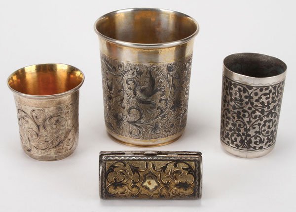 A FOUR-PIECE RUSSIAN SILVER AND NIELLO GROUPING: A FOUR-PIECE RUSSIAN SILVER AND NIELLO GROUPING, CIRCA 1850-1900. Comprising a large silver-gilt beaker nielloed with scrolling foliage. Hallmarked Moscow, dated 1854, Cyrillic maker's marks AR, and 8