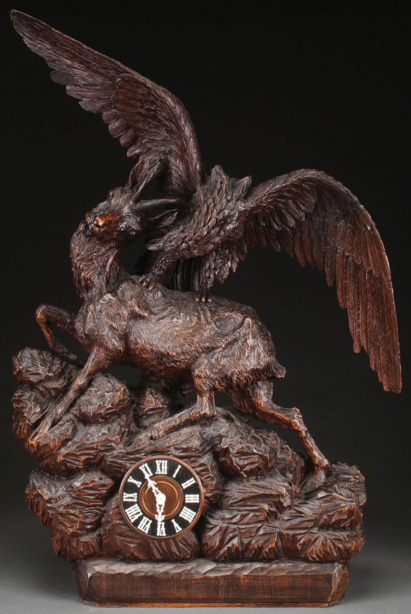 A LARGE AND IMPRESSIVE SWISS CARVED BLACK FOREST: A LARGE AND IMPRESSIVE SWISS CARVED BLACK FOREST FIGURAL CLOCK, EARLY 20TH CENTURY. Finely sculpted carved Linden wood model of an eagle attacking a chamois on a rockery outcrop, containing a spring w