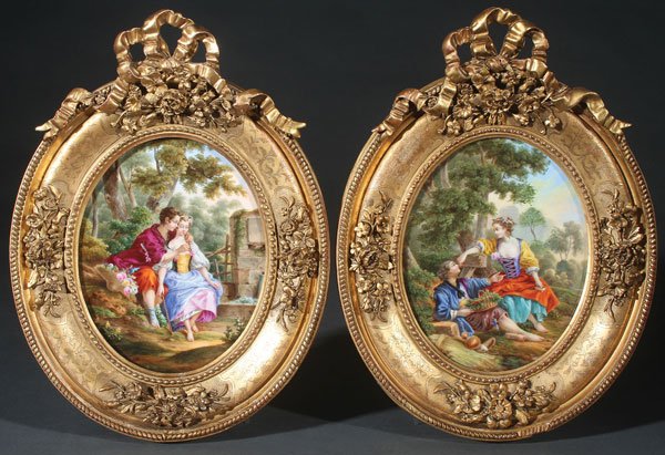 A PAIR OF CONTINENTAL HAND-PAINTED PORCELAIN: A PAIR OF CONTINENTAL HAND-PAINTED PORCELAIN PLAQUES, PROBABLY DRESDEN, EARLY 20TH CENTURY. Of oval form, each painted with a romantic courting scene and contained in ornate gilt gessoed frames with a