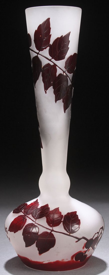 A DELATTE FRENCH CAMEO ART GLASS VASE.: A DELATTE FRENCH CAMEO ART GLASS VASE. EARLY 20TH CENTURY. In gray colored glass overlaid with maroon and cut with a design of “Leaves and Berries.” Signed in cameo “DeLatte Nancy.” Height 8.1