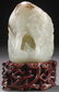 A CHINESE CARVED WHITE JADE BOULDER