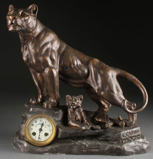 A LARGE FIGURAL “LIONESS AND CUB” MANTLE CLOCK: A LARGE FIGURAL “LIONESS AND CUB” MANTLE CLOCK, EARLY 20TH CENTURY. In patinated cast metal after Louis-Albert Carvin (French 1860-1951), signed on base “L. Carvin”. Height 17.75 inches (45 c