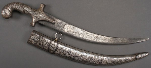 A LARGE AND FINE INDO-PERSIAN DAGGER: A LARGE AND FINE INDO-PERSIAN DAGGER. With slightly curved Damascus blade with decorative center medallion and ornately nielloed handle and scabbard. Entirely decorated on both sides. Overall length 1
