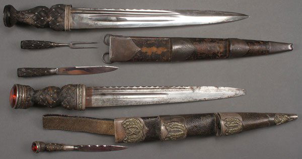 A PAIR OF VICTORIAN SCOTTISH DRESS DIRKS: A PAIR OF VICTORIAN SCOTTISH DRESS DIRKS. Both with polished blades with fuller and notched back edge, and with carved wood thistle basket weave hilt, set with polished German silver studs. The first