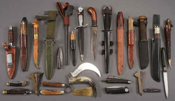 A GROUP OF 23 KNIVES AND DAGGERS, CIRCA 1825-1990: A GROUP OF 23 KNIVES AND DAGGERS, CIRCA 1825-1990. Representing a vast multitude of cultures including vintage folding pocket knives, a fine reproduction Fairbairn-Sykes fighting knife, boot knives, n