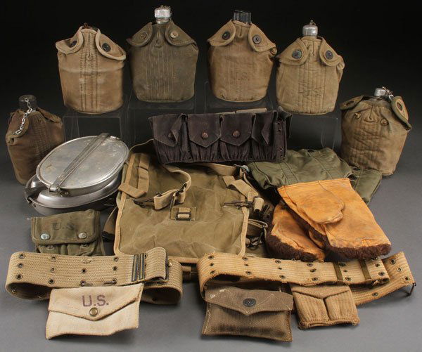 A GROUP OF 15 WWII PERSONAL FIELD GEAR ITEMS: A GROUP OF 15 WWII PERSONAL FIELD GEAR ITEMS, CIRCA 1918-1945. Comprising five aluminum canteens, three with WWI dates, one dated ‘43 the other ‘45, a nice British made for U.S. multi-purpose bag