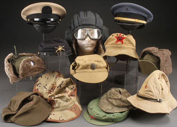 A GROUP OF 26 VARIOUS COUNTRIES MILITARY HATS: A GROUP OF 26 VARIOUS COUNTRIES MILITARY HATS, CIRCA 1900-PRESENT. Including British and Canadian wool berets, pith helmets, French bonni style bush hats, French overseas caps, West German Alpine cap