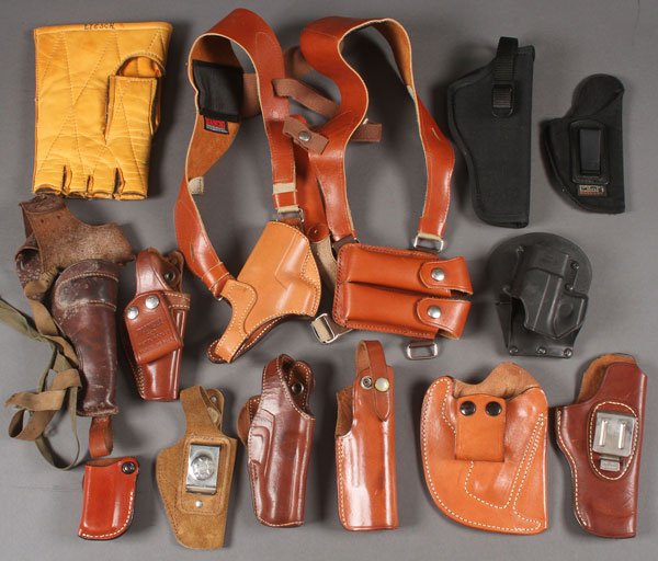 A GROUP OF 12 HOLSTERS AND OTHER MISCELLANEOUS: A GROUP OF 12 HOLSTERS AND OTHER MISCELLANEOUS ITEMS, CIRCA 1960-PRESENT. As well as shooting gloves, pistol bags, winter weather face guard, and other miscellaneous items.