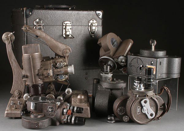 A VINTAGE MOTION PICTURE CAMERAS AND PROJECTOR GR: A VINTAGE MOTION PICTURE CAMERAS AND PROJECTOR GROUP, CIRCA 1930S AND 1940S. Comprising a Bell and Howell Filmo 70 and 70NR Victor model 4, a Bell and Howell Eyemo and an early Devry, together with a