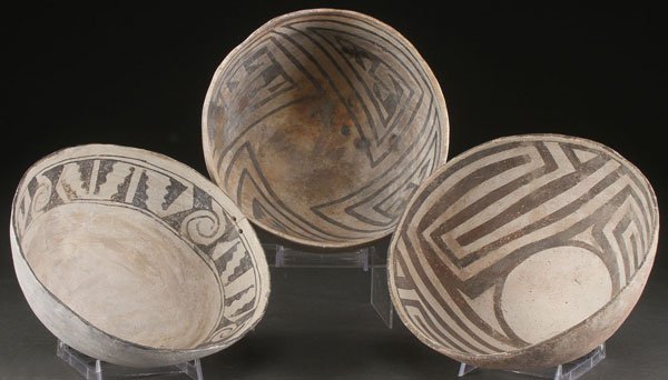 THREE PRE HISTORIC POTTERY BOWLS, ANASAZI: THREE PRE HISTORIC POTTERY BOWLS, ANASAZI, A.D. 1000-1200. Each with a different type of geometric design including angular ribs and spiral forms. The largest diameter 9 inches.