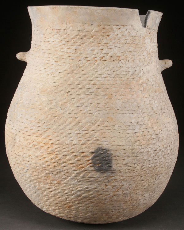 LARGE MESA VERDE CORRUGATED POTTERY OLLA: A LARGE PRE HISTORIC MESA VERDE CORRUGATED POTTERY HANDLED OLLA, ANASAZI, A.D. 1180-1300. Of good form with textured exterior. Some restoration and minor loss. Height 15 inches.