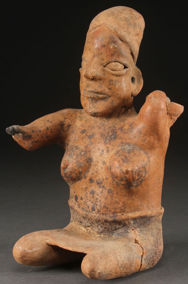 A LARGE PRE HISTORIC COLUMBIAN POTTERY FIGURE: A LARGE PRE HISTORIC COLUMBIAN POTTERY FIGURE. Depicting a seated nude female figure with molded skirt and right arm holding a bowl on shoulder. Legs reglued. Height 11.5 inches.