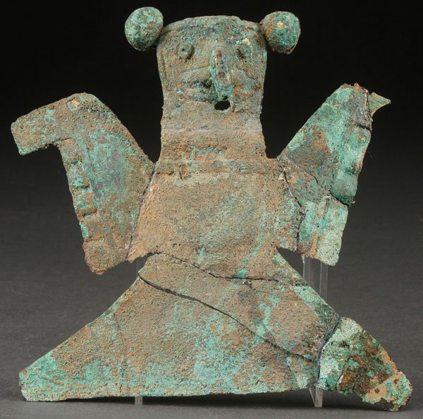 A EARLY MAYAN COPPER EFFIGY: A EARLY MAYAN COPPER EFFIGY. Shaped and molded sheet metal with encrusted verdigris oxidation and remnants of gilt. Height 6 inches.