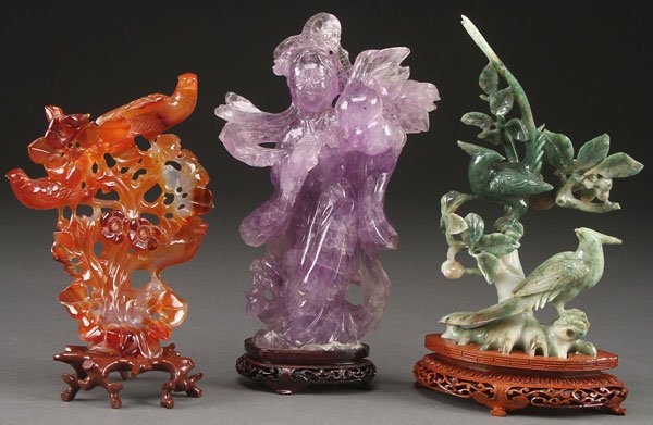 A THREE PIECE GROUP OF CHINESE CARVED JADE: A THREE PIECE GROUP OF CHINESE CARVED JADE AND HARDSTONE FIGURES, LAST HALF OF THE 20TH CENTURY. Comprising a carnelian agate pierced carved group of birds and florals, a jadeite group of birds on bra