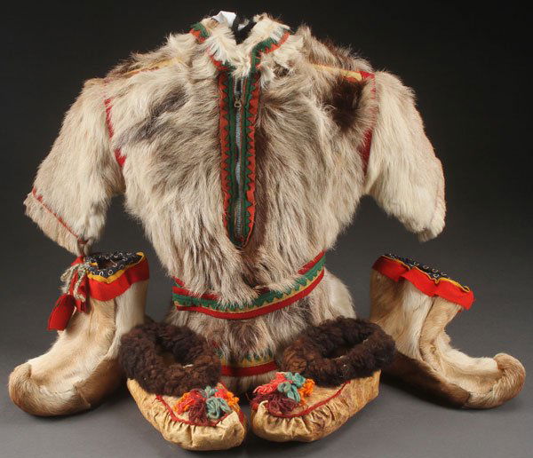 A LAPLANDER CHILD’S FUR JACKET, EARLY 20TH C: A LAPLANDER CHILD’S FUR JACKET, EARLY 20TH CENTURY. With multi-colored felt trim, together with a pair of Laplander fur boots and fur trimmed hide shoes. The jacket length 21 inches (53.5 cm).Proven