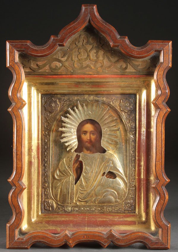 RUSSIAN PRESENTATION ICON, 1879: A FINE RUSSIAN PRESENTATION ICON OF CHRIST GIVEN TO MAJOR GENERAL J.K. MIRBACH, 1879. Contained in an ornate ogee arched glazed shadow box frame (kiot), the icon overlaid with an elaborate gilded silv
