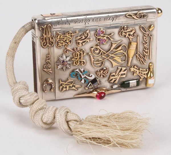 RUSSIAN SILVER SOUVENIR CASE: A VERY FINE RUSSIAN SILVER GILT AND ENAMEL SOUVENIR CIGARETTE CASE, ST. PETERSBURG, CIRCA 1898. The entire case profusely decorated with various gold, enameled and gem set charms. Including the breast