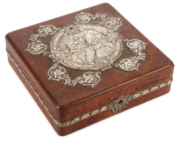 RUSSIAN OAK & SILVER METAL WEDDING BOX: A RUSSIAN OAK AND SILVERED METAL ARTS AND CRAFTS WEDDING BOX, CIRCA 1900. The flattened square form with rounded corners, the hinged lid displaying a large repoussed, silvered-metal medallion depictin