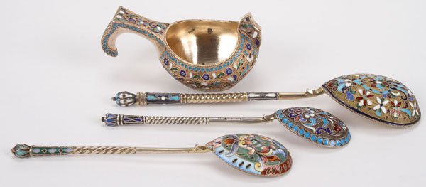RUSSIAN SILVER & ENAMEL ITEMS, MOSCOW, 1900: A RUSSIAN SILVER GILT AND CLOISONNE ENAMELED KOVSH AND THREE SPOONS, MOSCOW, CIRCA 1900. Comprising a kovsh of traditional form with raised prow and hook handle overall enameled in scrolling foliage o