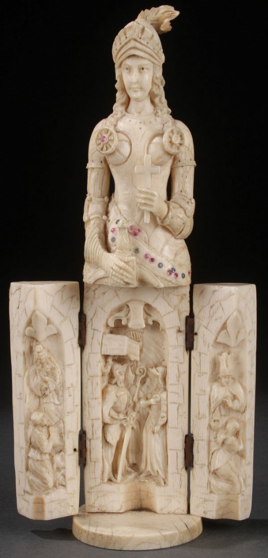 FRENCH CARVED IVORY TRIPTYCH, ST. JOAN, 19TH C.: A CARVED IVORY TRIPTYCH OF SAINT JOAN OF ARC, FRENCH, 19TH CENTURY. Carved in full round, of good proportion, cascading hair, deep folds, and elaborate armor holding a cross and sword and embellished 