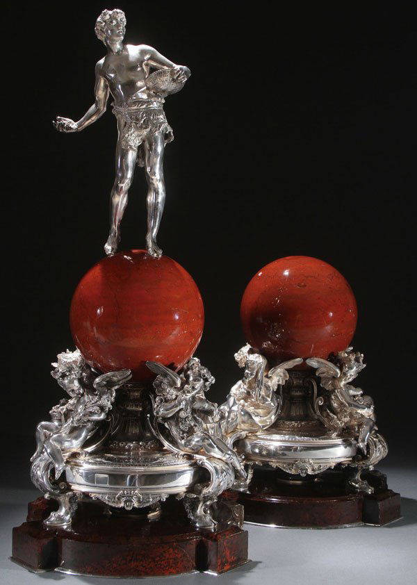 IMPRESSIVE SILVER & MARBLE TROPHIES, CHRISTOFLE: AN IMPRESSIVE PAIR OF FRENCH SILVER AND MARBLE TROPHIES BY CHRISTOFLE, CIRCA 1885. Comprising a figural silver base of four winged putti - one holding fruit, one with wheat, one with pine cones, and o