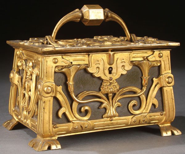 GILT BRONZE ART NOUVEAU DRESSER BOX: A VERY FINE FRENCH ART NOUVEAU GILT BRONZE AND LEATHER DRESSER BOX, CIRCA 1900. Of rectangular casted form, the open work panels and lid embossed in good relief with scrolled stylized florals over oli
