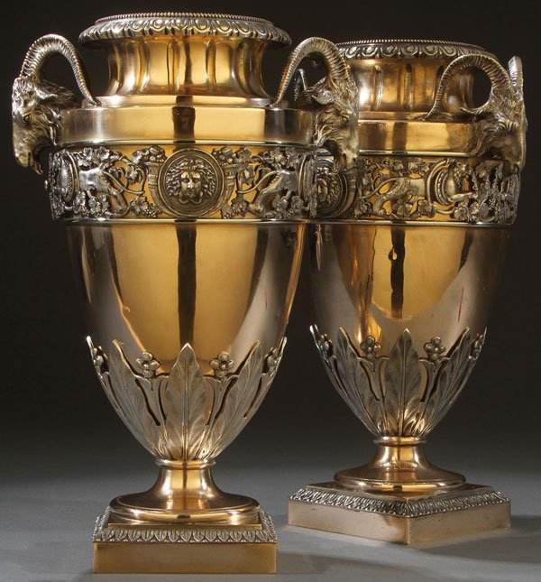 PAIR OF FRENCH POLISHED BRONZE URNS: A PAIR OF FRENCH EMPIRE SILVERED BRONZE HANDLED URNS, FIRST HALF OF THE 19TH CENTURY. The burnished bronze ovoid forms with concave fluted necks above each shoulder mounted with sculpted figural bronz