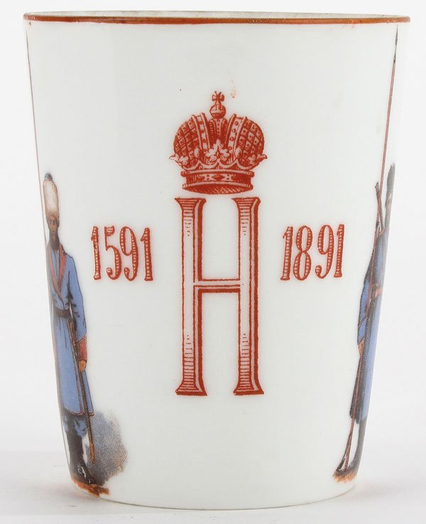 RARE RUSSIAN PORCELAIN COSSAK BEAKER KORNILOV 1891: A RARE RUSSIAN PORCELAIN BEAKER COMMEMORATING THE 300TH ANNIVERSARY OF THE COSSAK REGIMENT, 1591-1891, KORNILOV. The slightly flared cylindrical beaker decorated with two cossak warriors holding pikes
