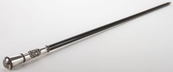 AN INTERESTING RUSSIAN STYLE SWORD CANE: AN INTERESTING RUSSIAN STYLE SWORD CANE. The ebonized wood shaft with brass tip and collar and mounted with an ornate silver handle set with a relief molded medallion of Saint George and the finial ca