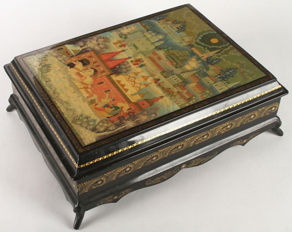 IMPRESSIVE RUSSIAN LACQUER WARE CASKET SIGNED: A LARGE AND IMPRESSIVE RUSSIAN HAND PAINTED LACQUERWARE CASKET, MSTERA, 2ND HALF 20TH CENTURY. Raised on four flared feet with serpentine skirt, the sides banded and with scrolling gilt foliate and th