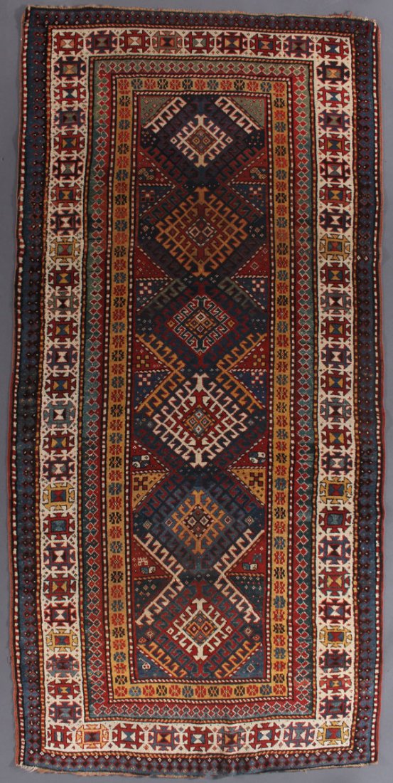 A KAZAK ORIENTAL RUG, SOUTHWEST CAUCASUS: A KAZAK ORIENTAL RUG, SOUTHWEST CAUCASUS, FIRST QUARTER 20TH CENTURY. 4 feet 3 inches x 8 feet 10 inches (129.5 x 269.2 cm). Provenance: From the lifetime estate collection of Jose Antonio Danobeitia 
