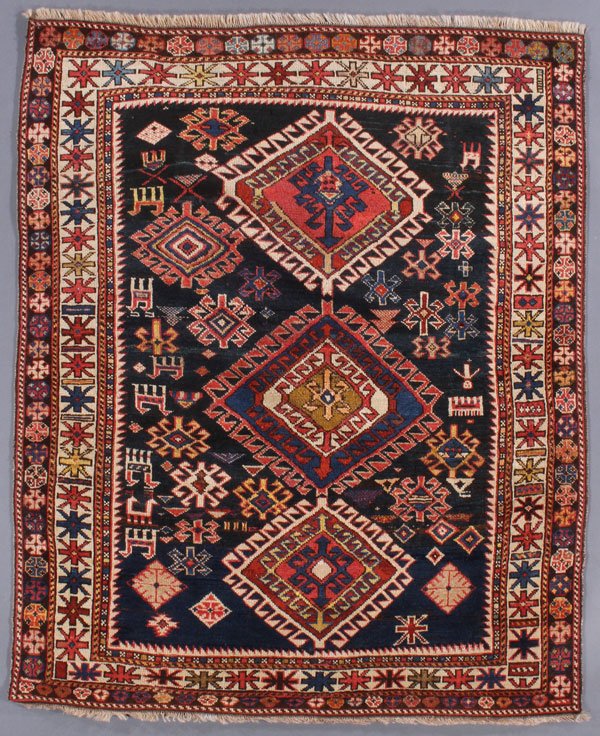 A CAUCASIAN GENJE ORIENTAL RUG: A CAUCASIAN GENJE ORIENTAL RUG, FIRST QUARTER 20TH CENTURY. 3 feet 7 inches x 4 feet 5 inches (109.2 x 134.6 cm). Provenance: From the lifetime estate collection of Jose Antonio Danobeitia (1942-2011)