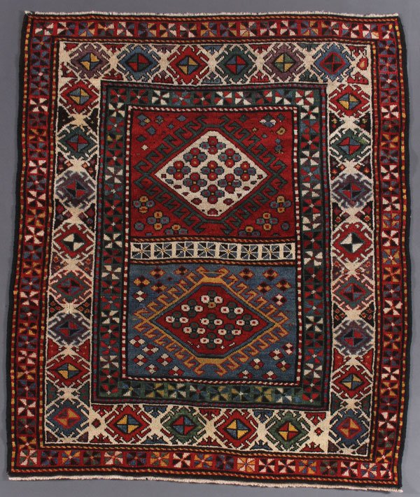 A TURKISH KAZAK ORIENTAL RUG: A TURKISH KAZAK ORIENTAL RUG, SECOND QUARTER 20TH CENTURY. 4 feet 5 inches x 3 feet 9 inches (134.6 x 114.3 cm). Provenance: From the lifetime estate collection of Jose Antonio Danobeitia (1942-2011).