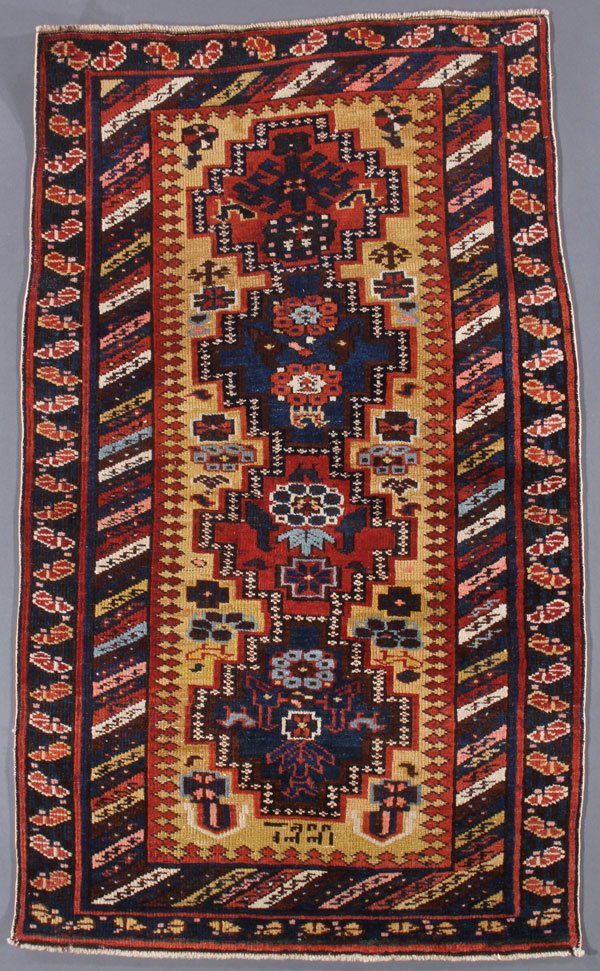 A SHIRVAN ORIENTAL RUG, EAST CAUCASUS, CIRCA 1915: A SHIRVAN ORIENTAL RUG, EAST CAUCASUS, CIRCA 1915. Dated 1915. 2 feet 10 inches x 4 feet 9 inches (86.4 x 144.8 cm). Provenance: From the lifetime estate collection of Jose Antonio Danobeitia (1942-20